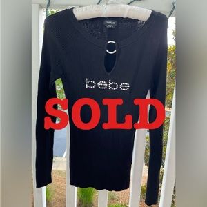 BEBE thin long sleeve top with center embellishment